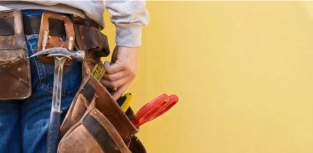 Handyman with tool belt ready for home repairs and maintenance in Stockton, CA