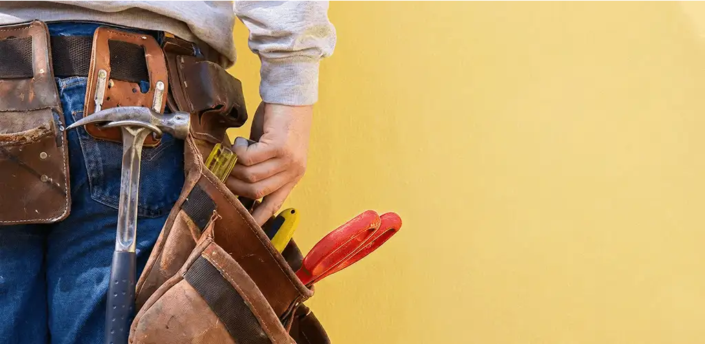 Handyman with tool belt ready for home repairs and maintenance in Stockton, CA