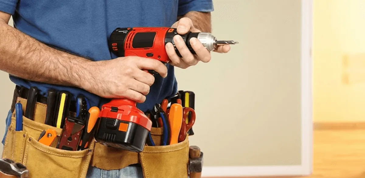 Handyman holding a power drill for home repairs and installations in Stockton, CA