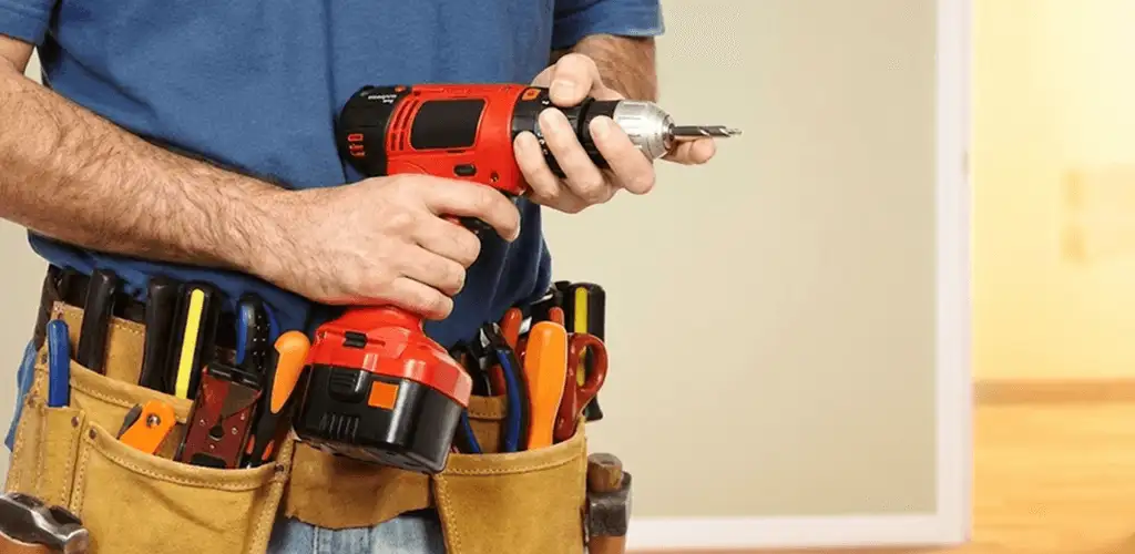 Handyman holding a power drill for home repairs and installations in Stockton, CA