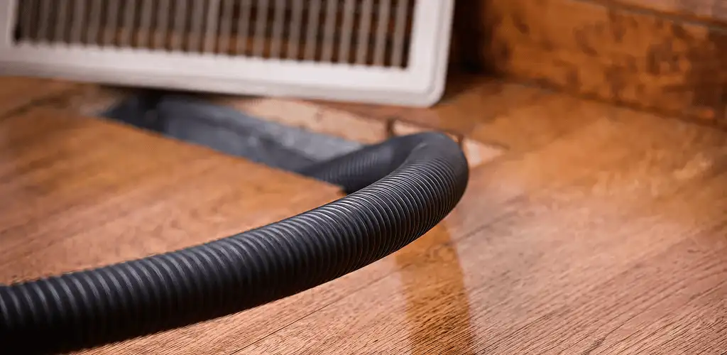 Air duct cleaning hose inserted into a floor vent for ductwork cleaning in Stockton, CA