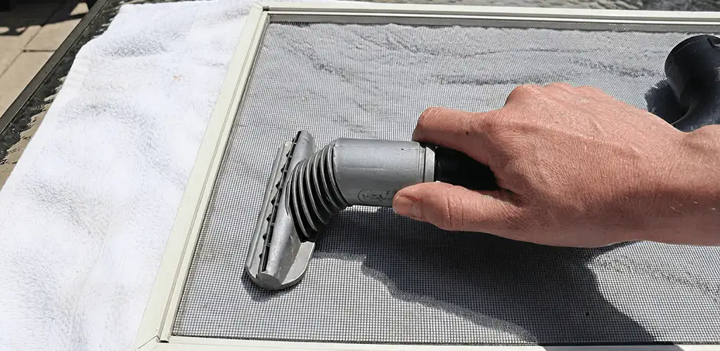 Window screen repair cleaning and fixing a damaged screen mesh in Stockton, CA